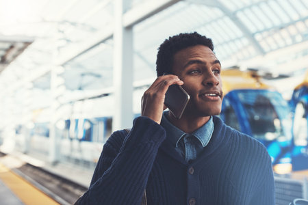 Hes got that go getter type of determination. a young businessman using a mobile phone while walking through the subway.の写真素材