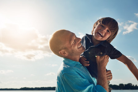 Fatherhood is the best thing that ever happened to me. a middle-aged man and his young son spending some quality time at the beach.の写真素材