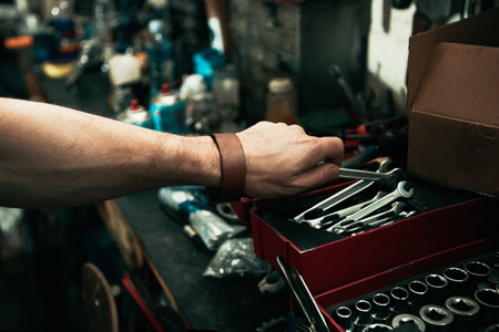 The best repairmen work with the best tools. mans hand reaching for a tool from his toolbox.の写真素材