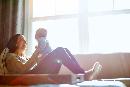 He lights up her life. a young woman bonding with her baby boy on the sofa at home.