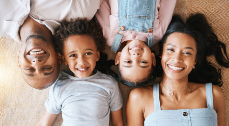 Family, portrait and top view smile in house, bonding or having fun together. Parents, happiness above and children relaxing or lying on carpet floor with man and woman, care or enjoying quality timeの写真素材