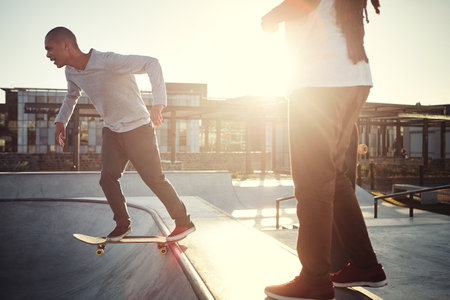 Skating is a lifestyle. two young men skating together on their skateboards at a skate park.の写真素材