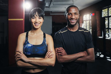 We enjoy working out together. Portrait of two young people at the gym for a workout.
