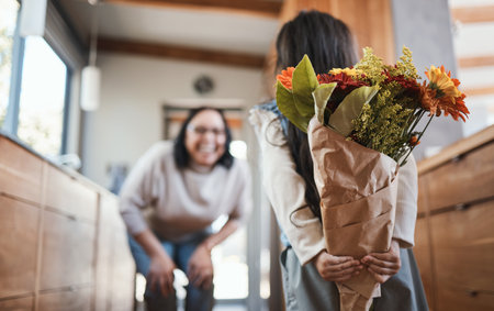 Surprise flowers, mothers day and a mother and child for a gift, birthday or gratitude for care. Love, smile and a girl kid hiding floral bouquet from mom for celebration, special event or happinessの写真素材