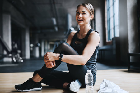 Theres nowhere shed rather be. Full length shot of an attractive young woman working out in the gym.の写真素材