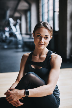 I feel at home in the gym. Cropped portrait of an attractive young woman working out in the gym.の写真素材