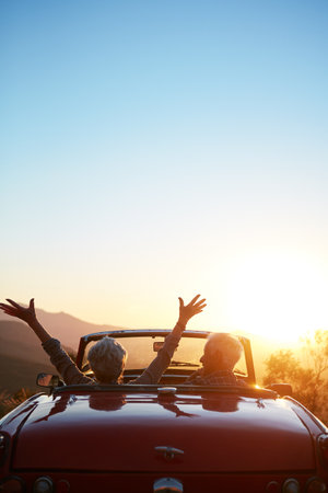 No regrets. a joyful senior couple enjoying the sunset during a roadtrip.の写真素材