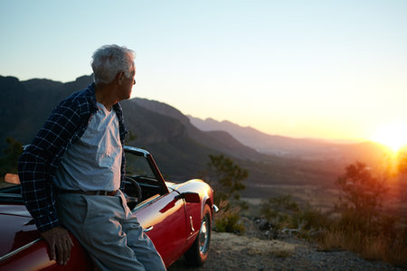 In solitude there is also freedom. a senior man out on a road trip.の写真素材
