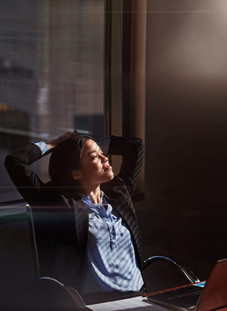 Hard work always pay off. a businesswoman sitting thoughtfully in her office.