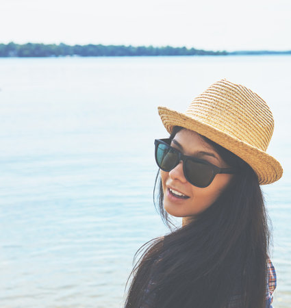 The water looks good. an attractive young woman enjoying a day on the beach.の写真素材