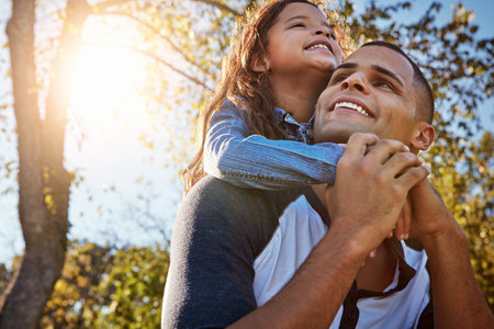 Little people give the biggest love. a happy father and daughter spending time together outdoors.の写真素材