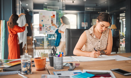 Inspiration will find you. Shot of a young businesswoman working in an office.の写真素材