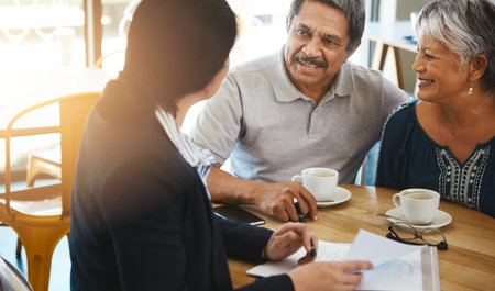 Make good decisions while youre healthy and able. a senior couple meeting up with a financial advisor.の写真素材