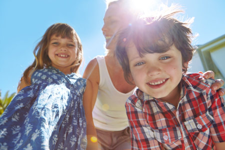 Family makes the summer extra special. a happy family of three enjoying a sunny day in their backyard.の写真素材