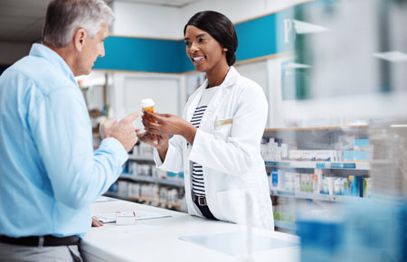Im positive that this will treat your symptoms. a female pharmacist assisting a customer in a drugstore.の写真素材