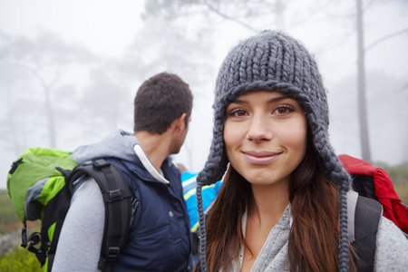Happiest when out hiking. Portrait of an attractive young woman out hiking with her boyfriend.の写真素材