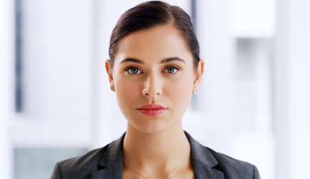 Time to handle some serious business. Portrait of an attractive young businesswoman looking serious in her office.の写真素材
