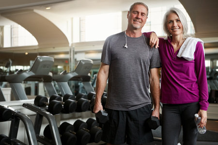 Getting fit together. a senior married couple smiling and taking a break from their workout at the gym.の写真素材