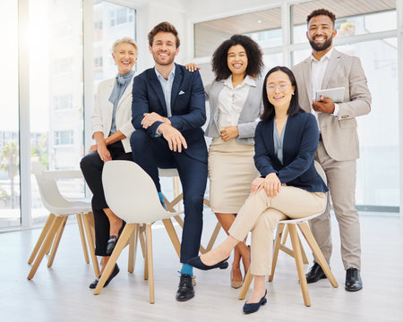 Success, happy and portrait of business people on chair in office with confidence, pride and motivation. Teamwork, diversity and group of men and women smile for goals, company mission and happinessの写真素材