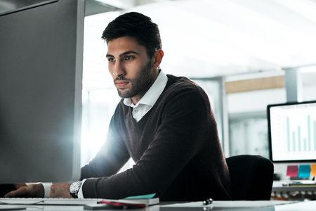 Creating quality content is only the beginning. a young businessman working on his computer at his...