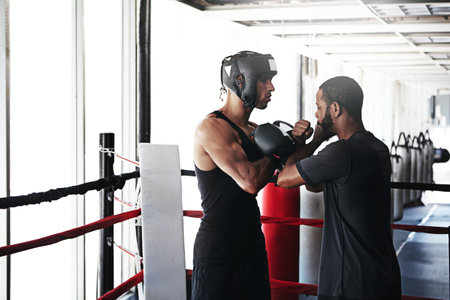 Two of the greatest in one ring. a man training in the boxing ring with a coach.の写真素材