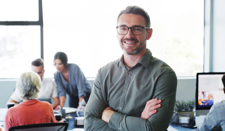 Our team can out perform any team. Portrait of a confident mature businessman working in a modern...