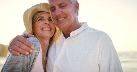 Youre truly my favourite person on earth. an affectionate senior couple embracing each other at the beach at sunset.の写真素材
