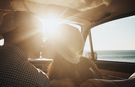 They couldnt resit a kiss. an affectionate young couple enjoying a road trip along the coast.の写真素材