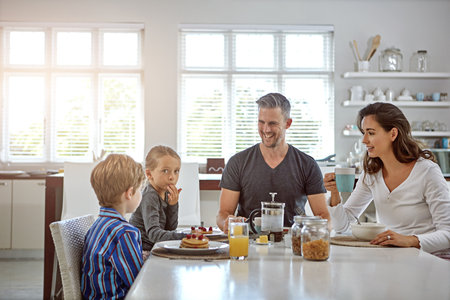 Its important to start your day with breakfast. a family having breakfast together.の写真素材