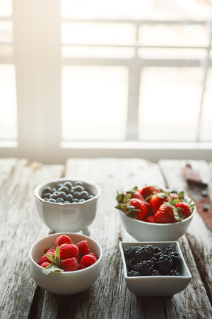 Healthy food brightens up any table. bowls of various berries on a table.の写真素材