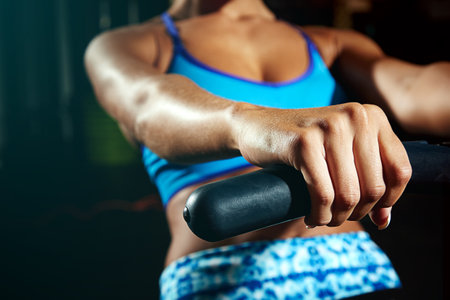 Do it for the body youve always wanted. a young woman working out on a rowing machine.の写真素材
