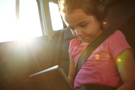 Movies are a road trip must have. a little girl traveling in a car.の写真素材
