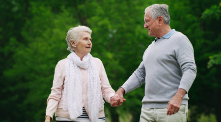 Love leads you down the right path. a happy senior couple spending a romantic day in the park.の写真素材