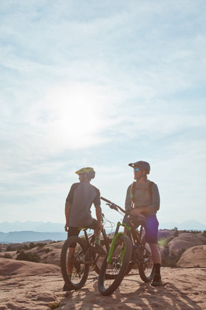 Mountain biking does the body good. Full length shot of two athletic men taking a break to admire...