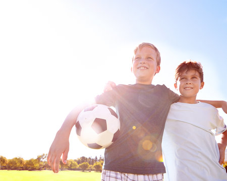Soccer with my best friend. two young friends enjoying a day playing soccer.の写真素材