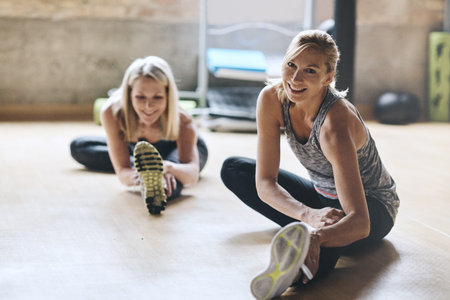 We never miss a class when it comes to fitness. mature women working out at the gym.