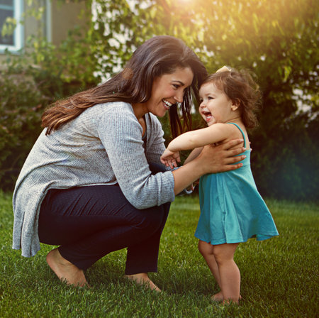 Youre so unbelievably cute. a mother bonding with her adorable little daughter outside.の写真素材