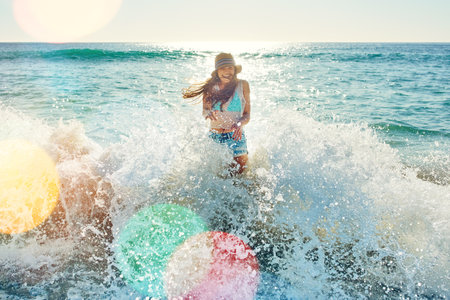 Committed to being happy and enjoying life. a beautiful young woman spending the day at the beach.の写真素材