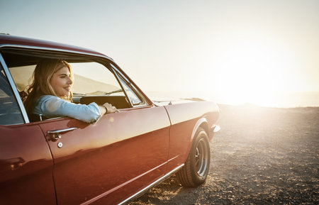 This trip is exactly what I needed. a young woman enjoying a road trip along the coast.の写真素材