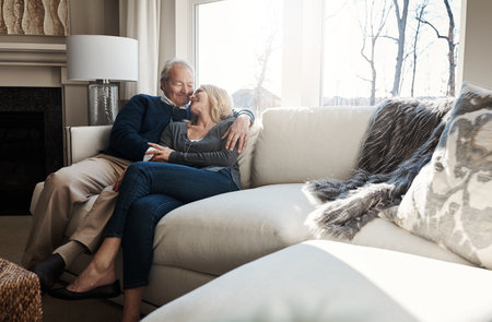My one and only forever and ever. a loving mature couple relaxing together at home.の写真素材
