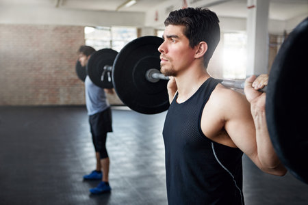 That was a clean lift. young men working out with weights in the gym.の写真素材