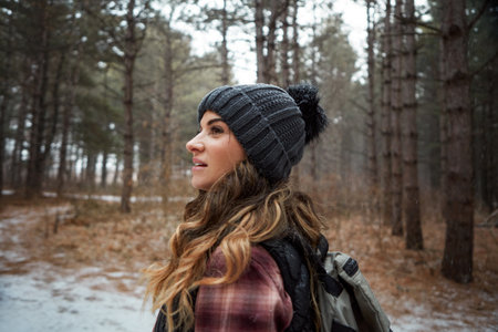 After a hike, everything holds twice its usual value. a young woman hiking in the wilderness during winter.の写真素材