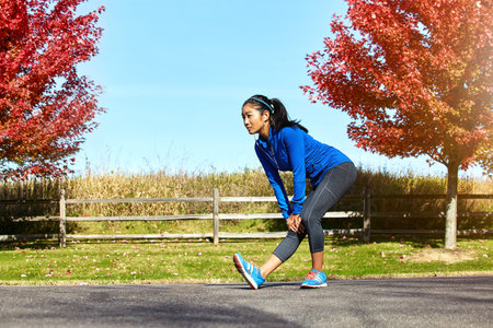 Got to stretch every joint and muscle. a sporty young woman stretching her legs while exercising...