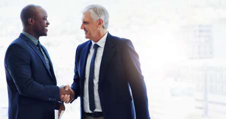 Lets show everyone what great success is. two businesspeople shaking hands.