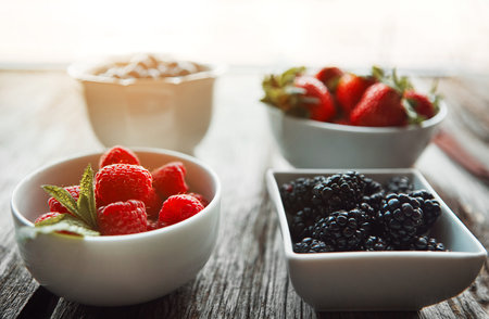 Beautiful ripe berries. bowls of various berries on a table.