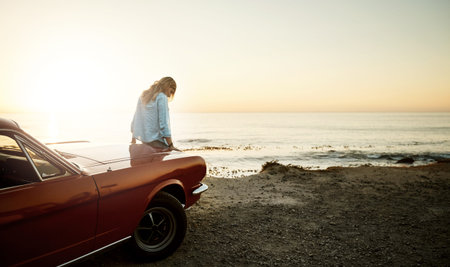 Go out and experience the wonderful world. a young woman enjoying a road trip along the coast.