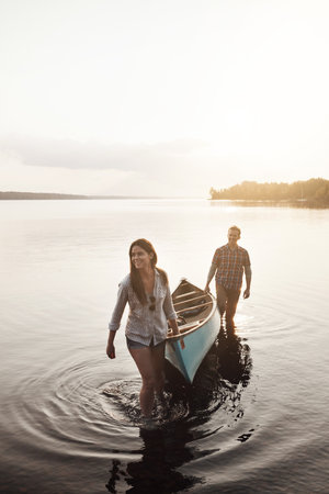 Our adventure on the lake was fun. a young couple coming from a canoe ride on the lake.の写真素材