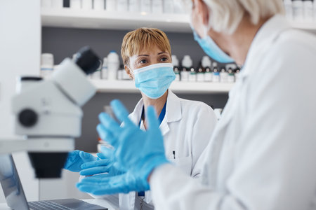 Science women, talking and research in a laboratory for scientist investigation or collaboration....