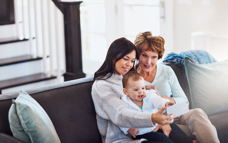 Family selfies have that extra specialness. a young woman taking selfies with her baby girl and...