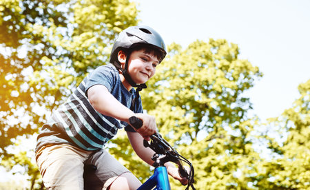 Riding round the neighbourhood. a young boy riding his bicycle through his neighbourhood.の写真素材